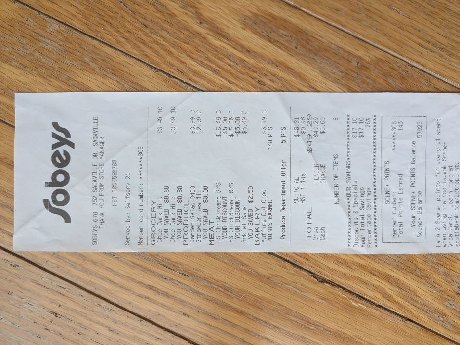 Original photo: a receipt lying sideways and slightly tilted on a wooden floor, in color